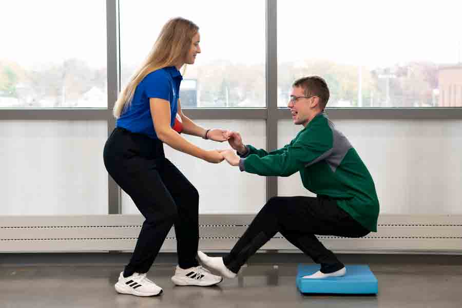 Drake Kinesiology majors practice balance exercises in preparation for strength and conditioning and personal training careers 
