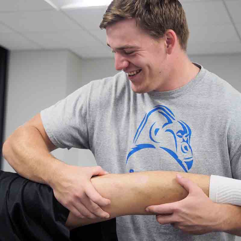 A Drake Kinesiology student practices adjustment techniques in a campus lab