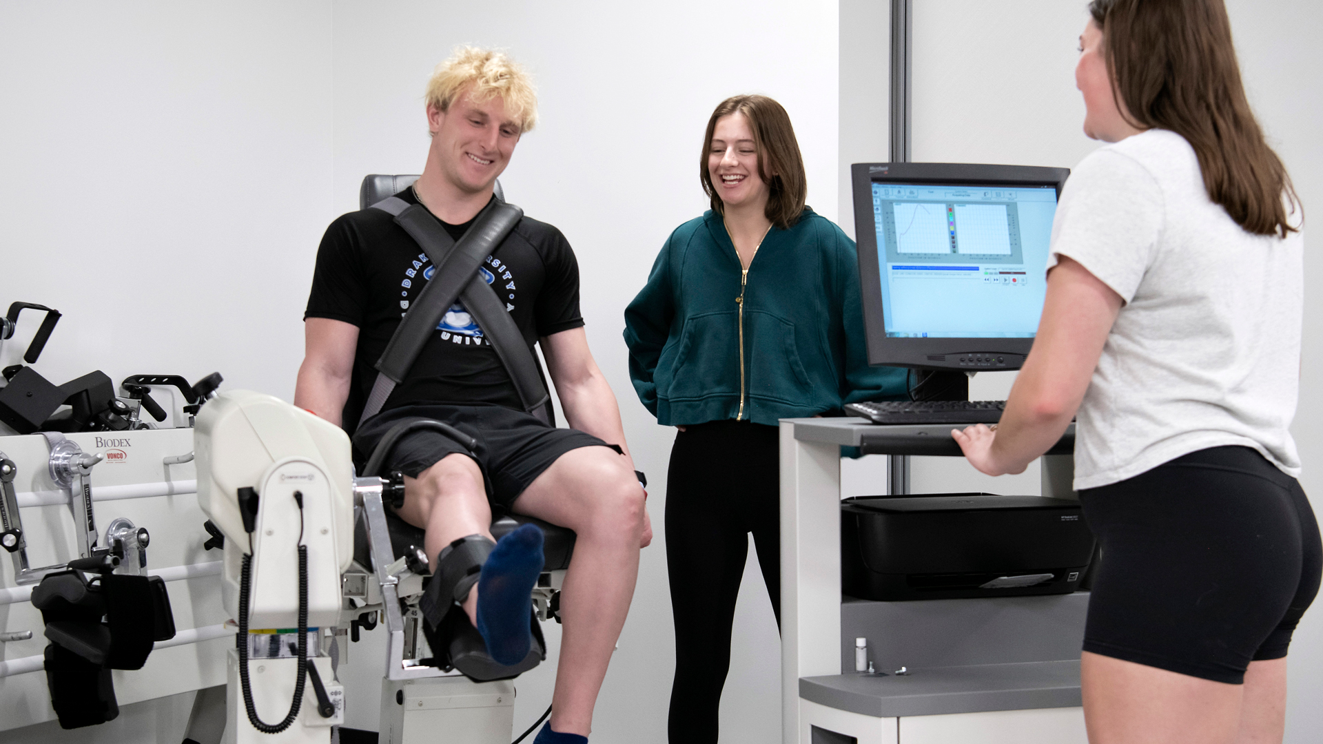 Three Drake Kinesiology majors test body composition in one of the campus's exercise labs