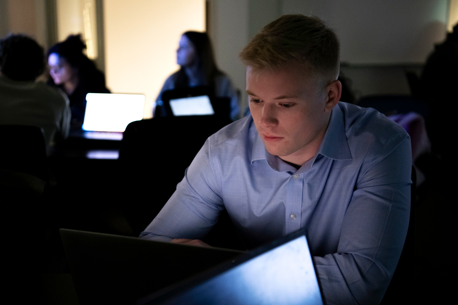 Mathematics students review a presentation on their laptops in a Drake computer lab