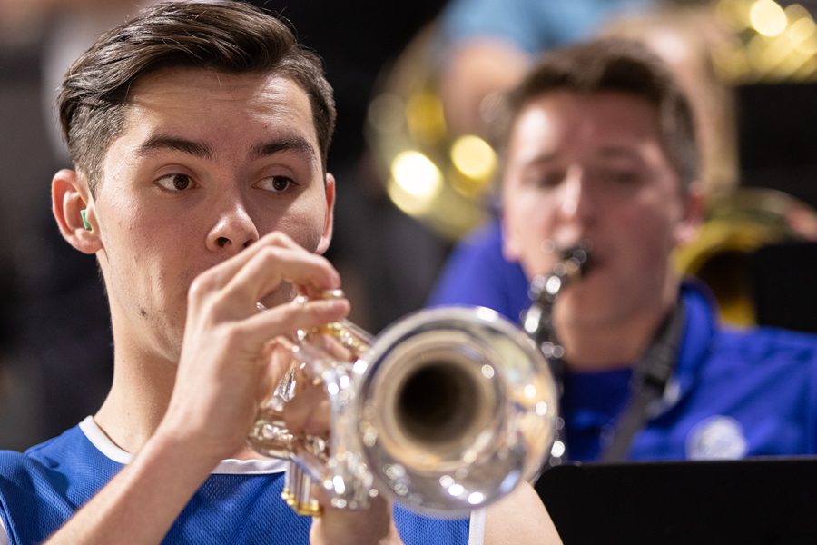 A trumpet player in one of Drake's student bands performs during a basketball games