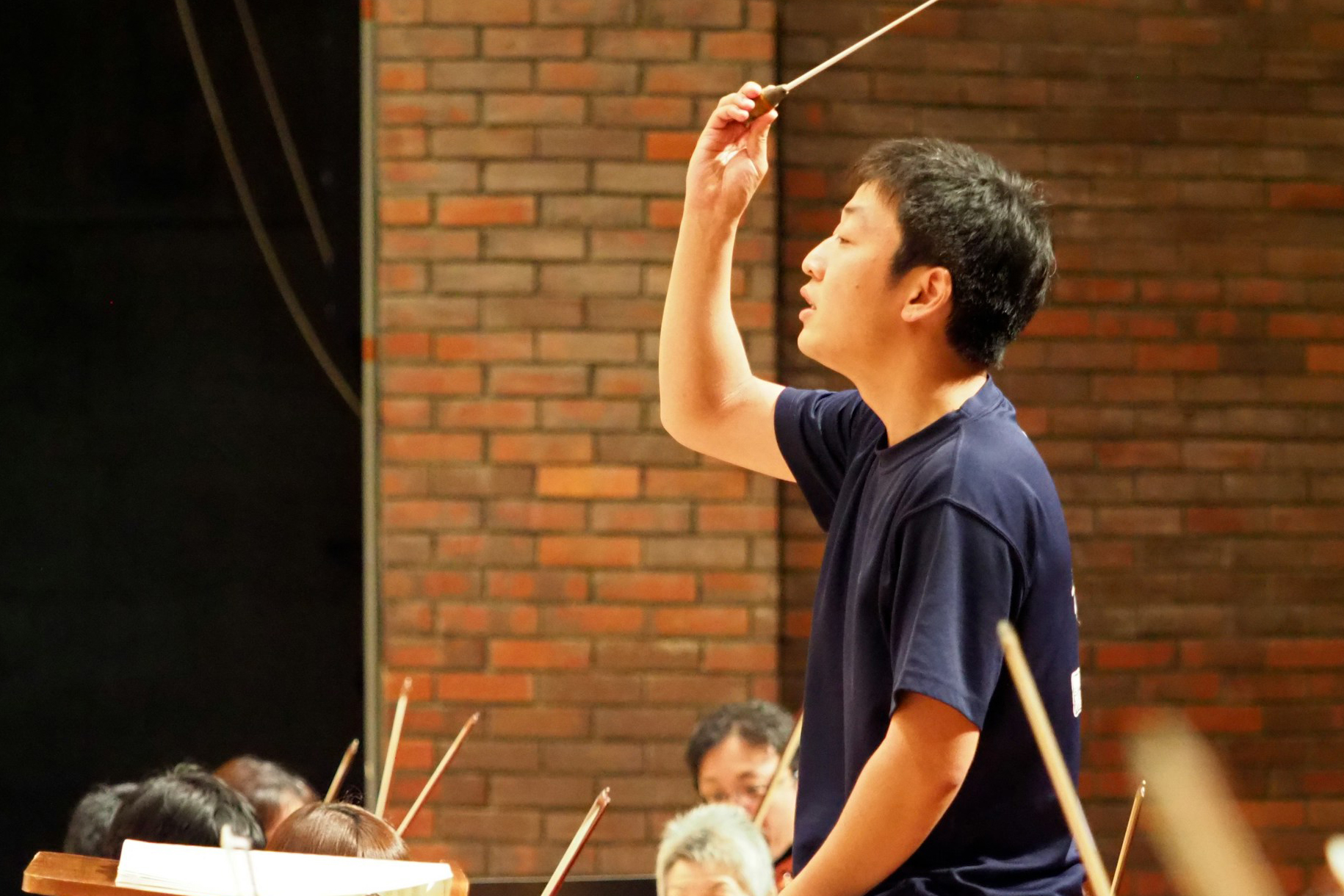 A Drake Music Education major practices their conducting skills with an on-campus student ensemble