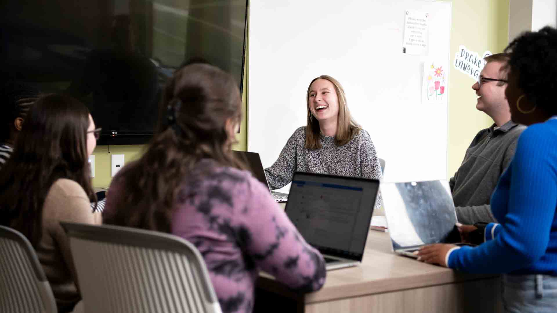 A group of Drake Philosophy students engage in a lively discussion at the start of class