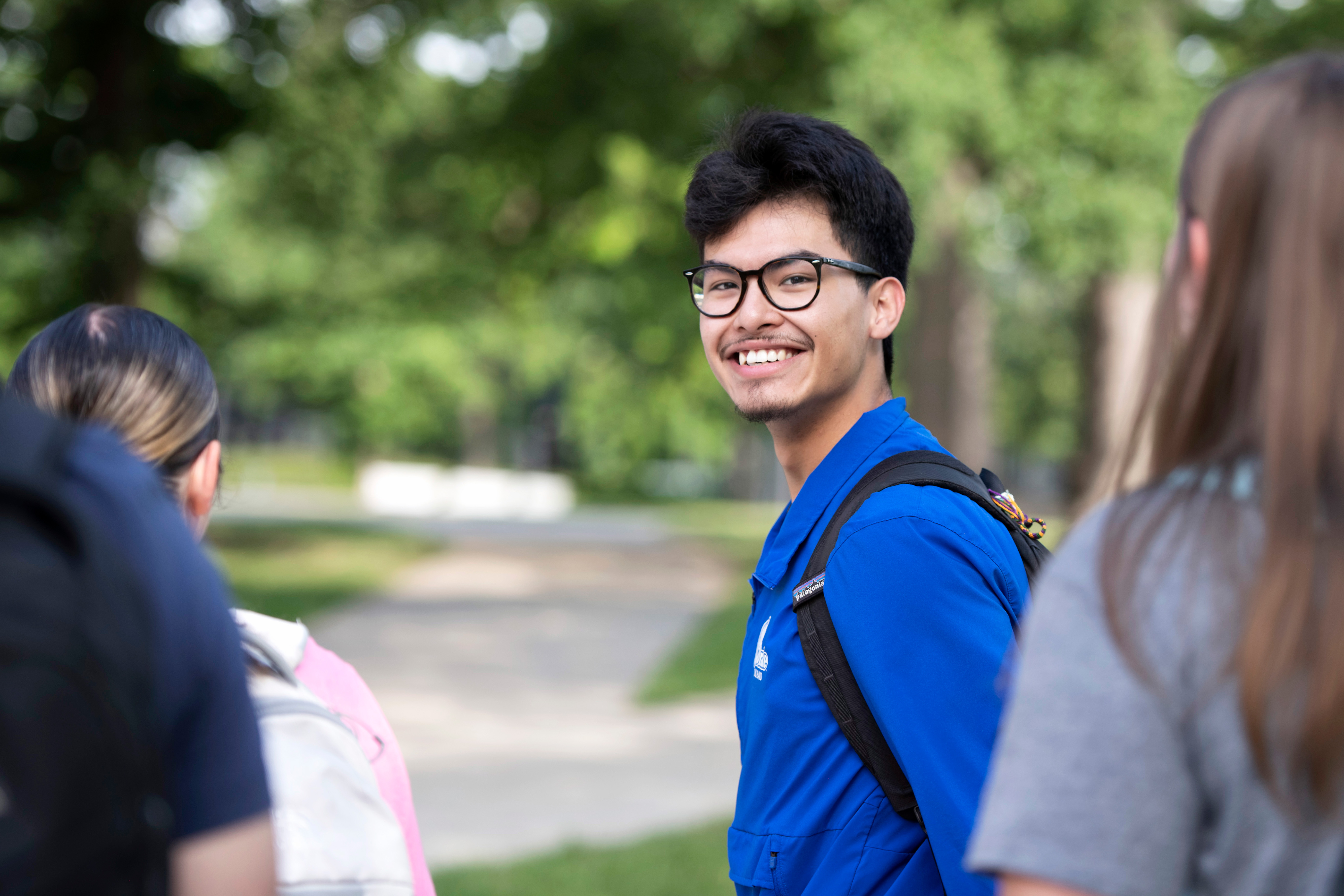 A Drake Philosophy student leads a group of campers as an interfaith youth camp volunteer