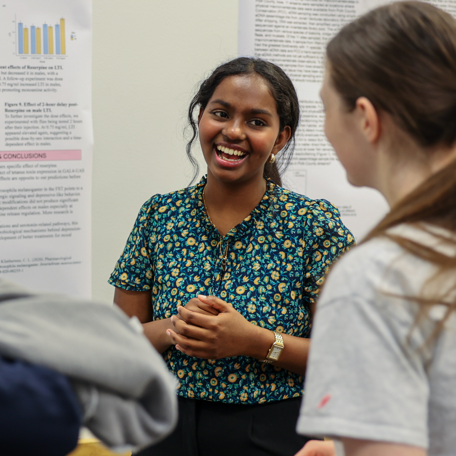 A Drake Physics student explains their research during a campus presentation