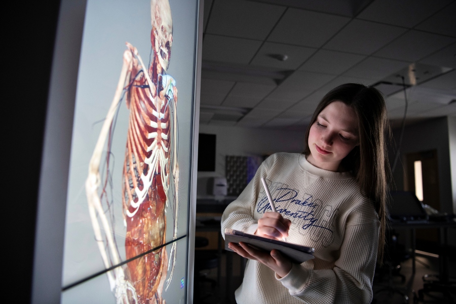 Ahead of taking the MCAT exam, a Pre-Med student explores the human body with an anatomage table, taking notes as they do
