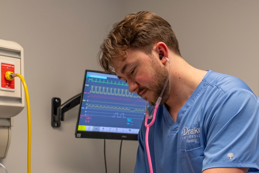 A Drake Pre-Nursing student learns to take vitals with a stethoscope