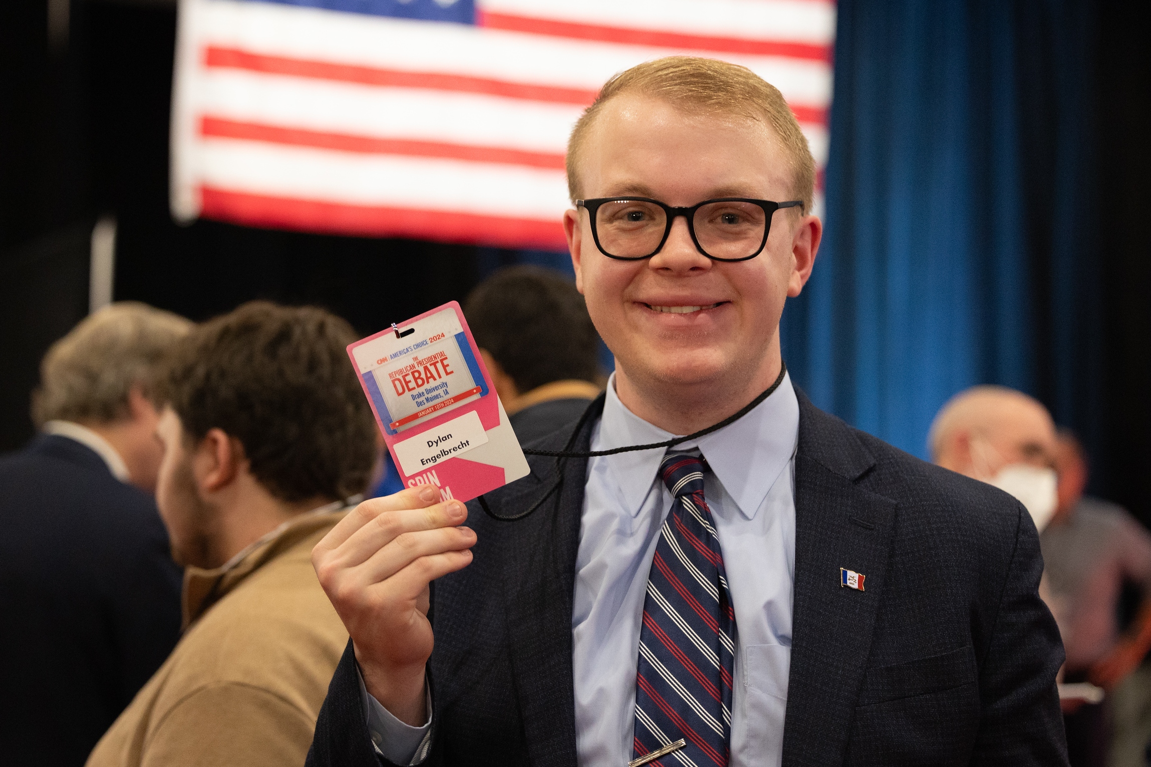 A student from Drake's Strategic Political Communication program holds up their pass to attend to Republican Presidential Debates