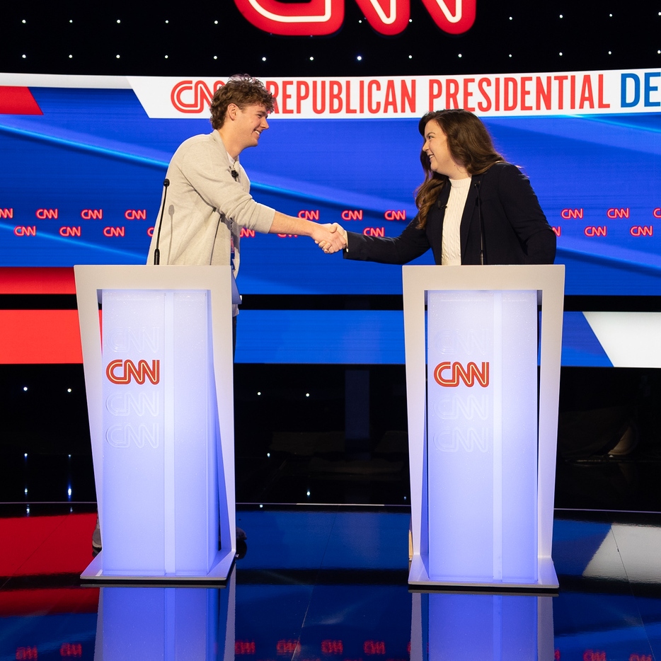 A Strategic Political Communication student shakes hands with a communications professional before the Republican Primary Debates begin