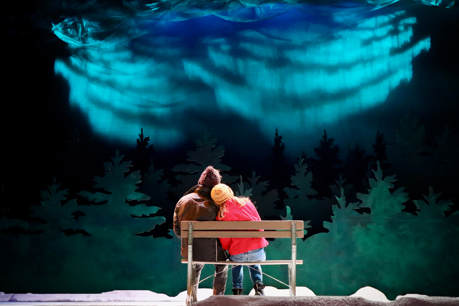 Two Theatre Majors at Drake stare into the aurora borealis scenery during a production of Almost Maine