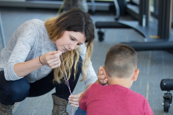 A teacher working with a child on a project