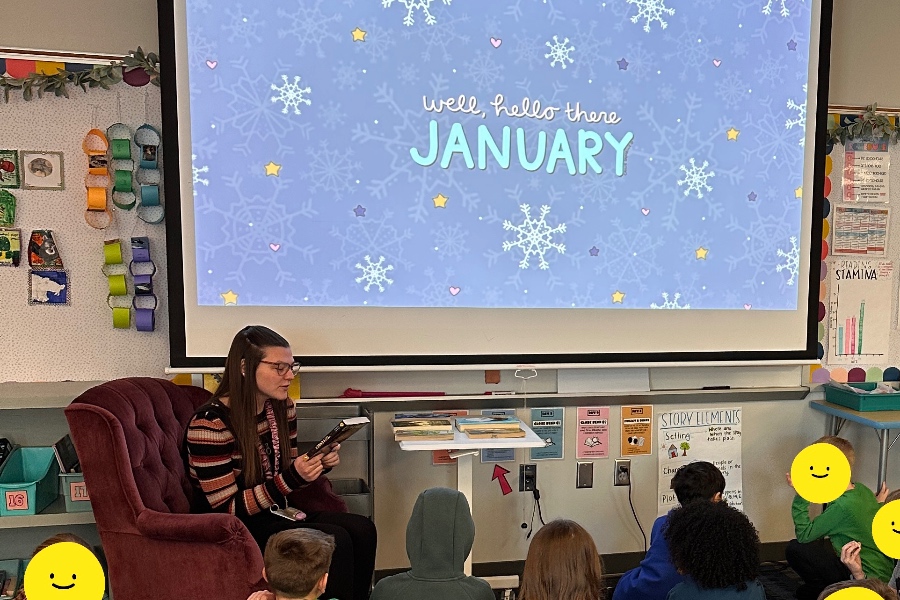 A teacher reading to an elementary class