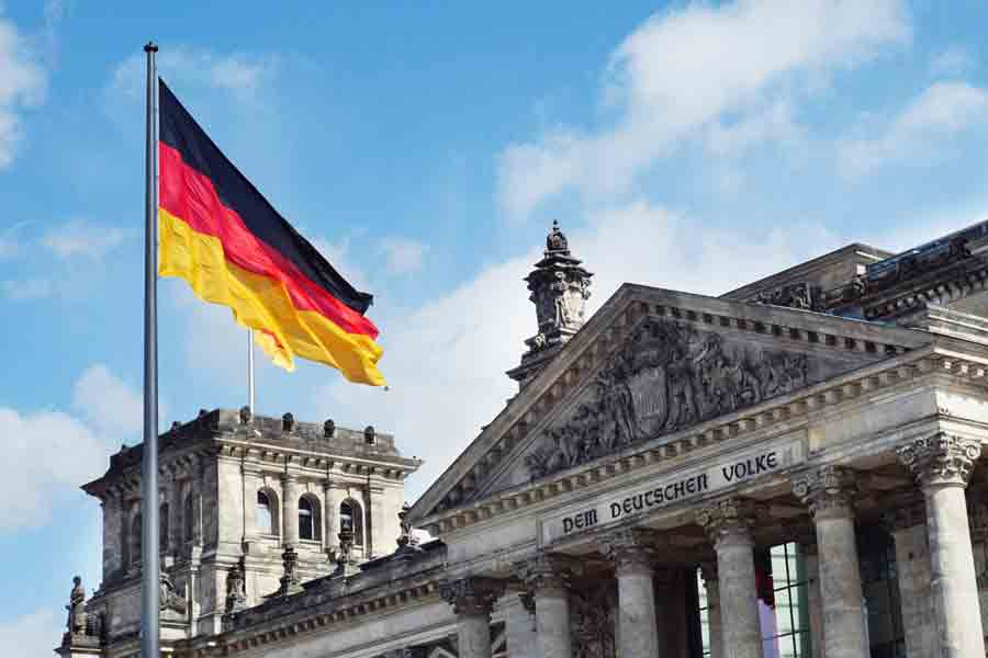 A historical building in Germany with the German flag in the foreground