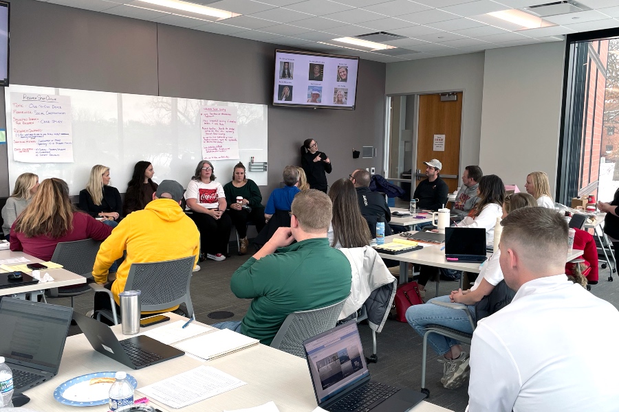 class listening to alumni who now work in school districts
