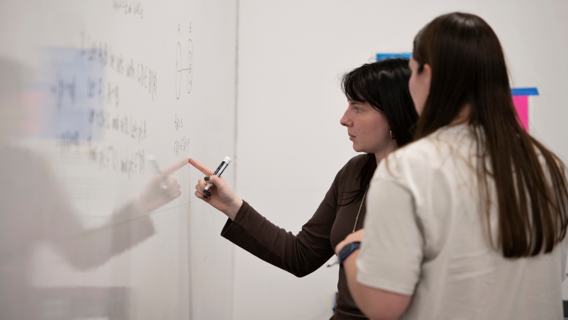 Two students at a white board