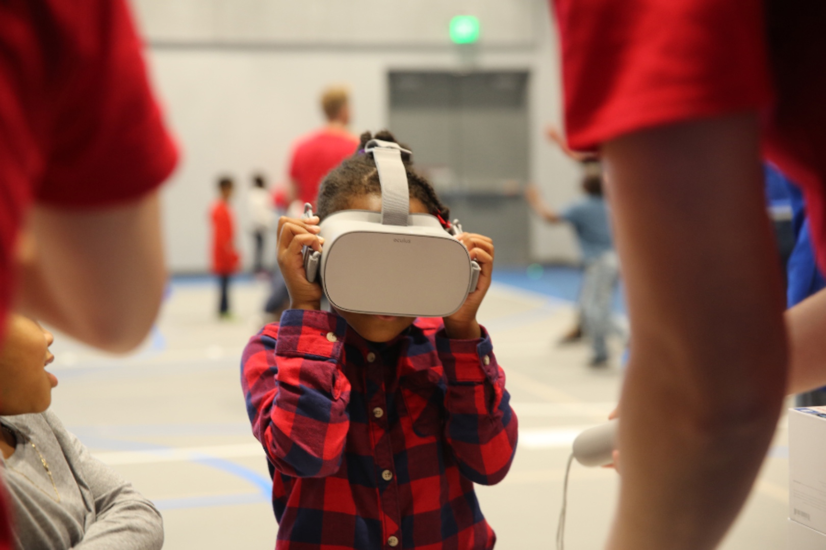 An elementary aged child trying on a VR headset at a stem fair