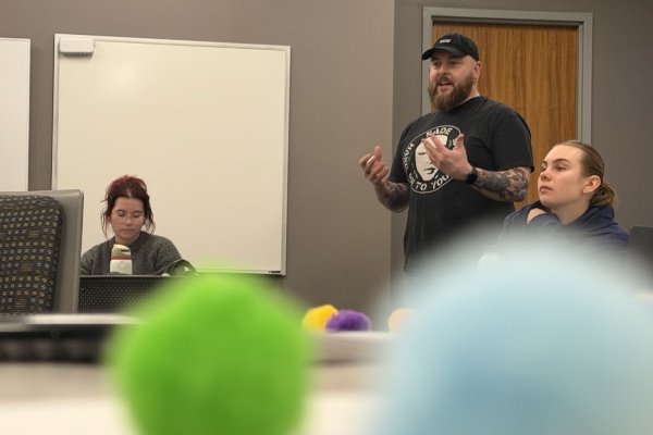 A student speaking with colorful spots in the foreground