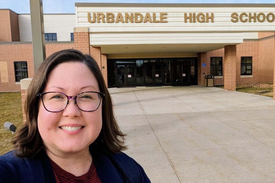 A student teacher taking a selfie in front of Urbandale High School