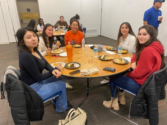 Students gathered around a table for the Latinx celebration