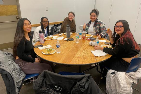 Students around a table for the Latinx gathering celebration