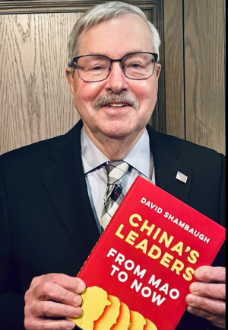 Ambassador Terry Branstad holding the Spring 2022 book club selection
