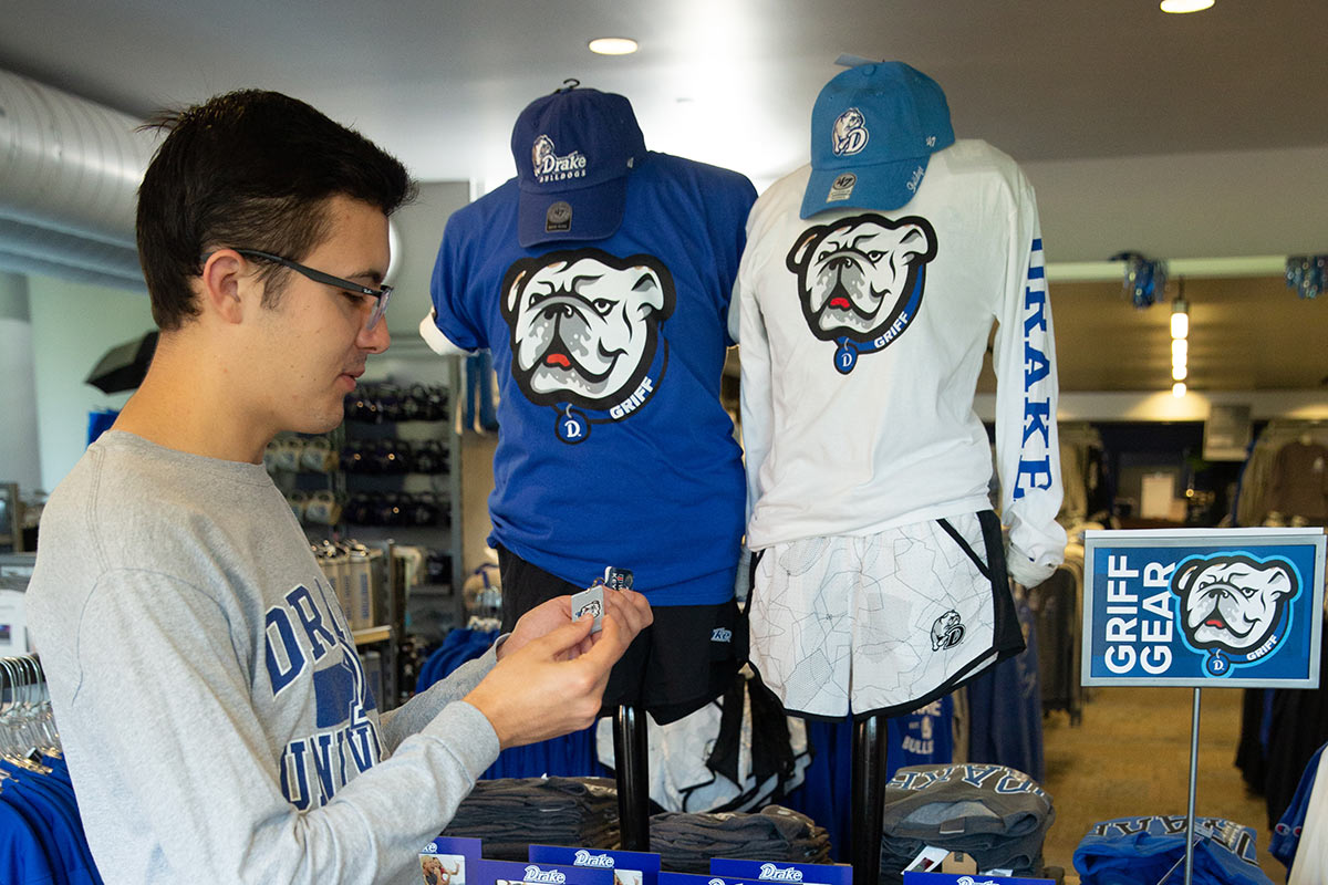 A student shopping for Griff Gear at the Drake bookstore on campus