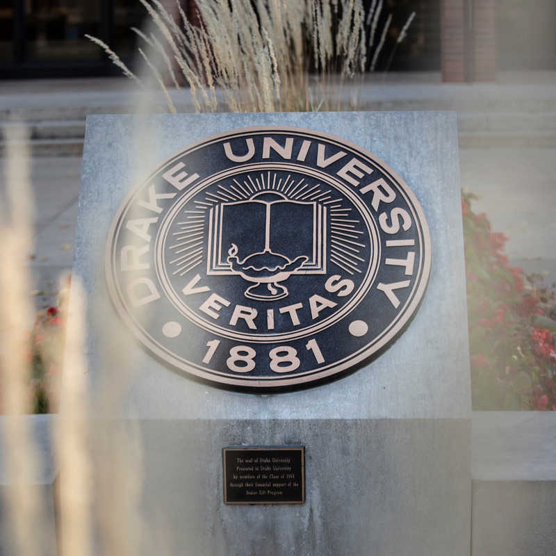 Drake University seal with wheat and flowers around it.