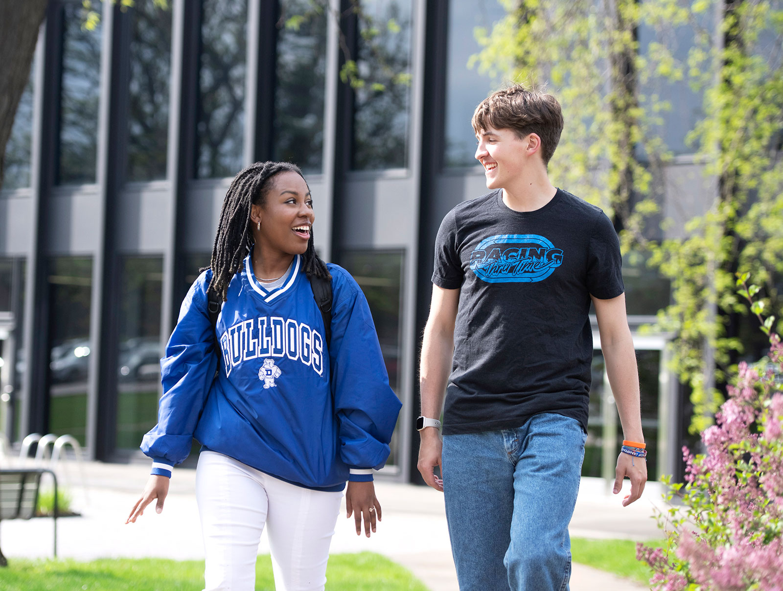 Two Drake students walking and talking outside Meredith Hall.