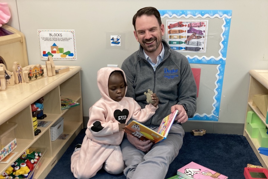 dean wise reading to a child in a headstart classroom