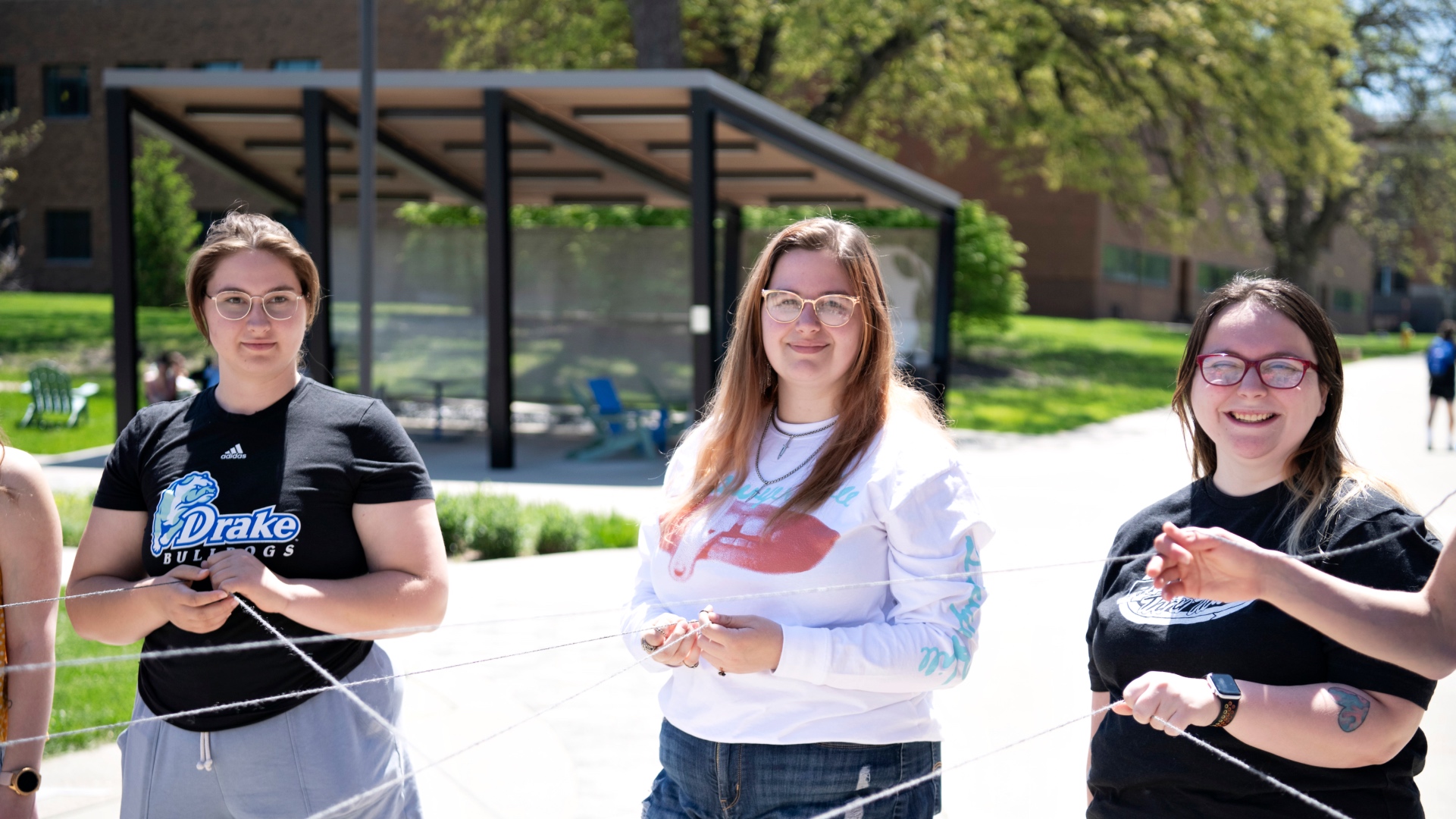 SOE students outside holding threads to demonstrate the interconnected nature of food webs